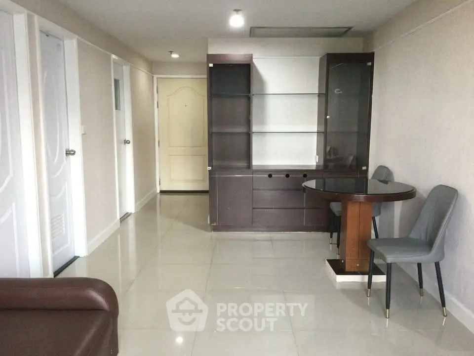 Spacious modern living room with sleek furniture and tiled flooring