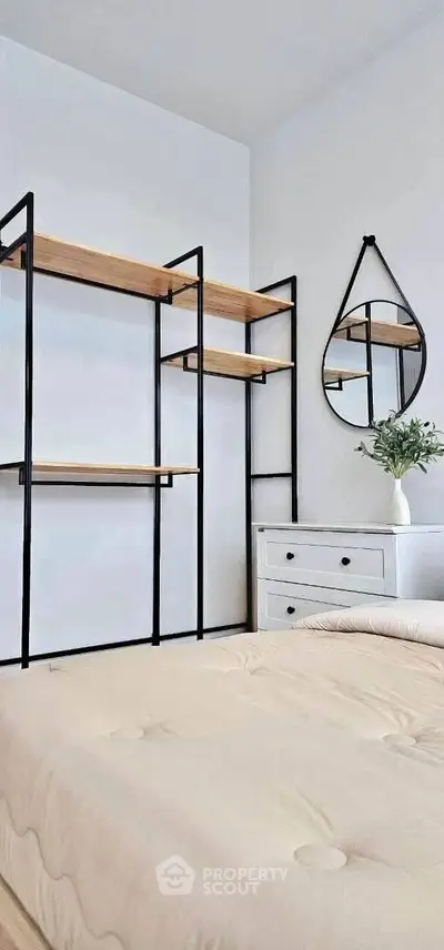 Modern bedroom with minimalist shelving and stylish mirror