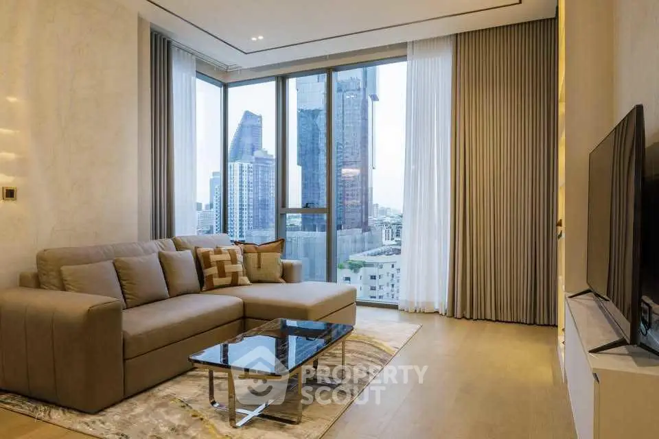 Modern living room with city view, featuring a sleek sofa and large TV, perfect for urban living.