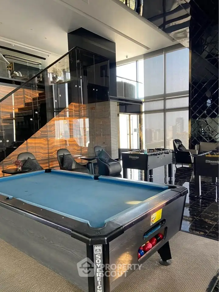 Luxurious modern living space with pool table and city view, perfect for entertainment.