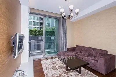 Modern living room with plush sofa and balcony view in urban apartment