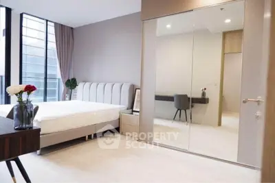 Modern bedroom with large mirrored closet and elegant decor