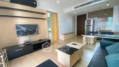 Modern living room with sleek furniture and open kitchen layout