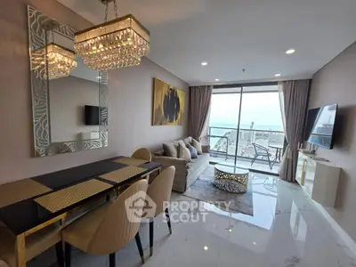 Luxurious living room with elegant decor and stunning city view from the balcony.