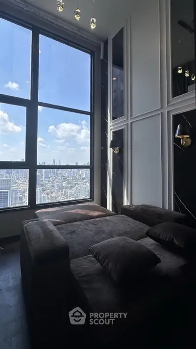 Luxurious living room with panoramic city view and elegant dark furnishings.