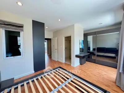 Spacious bedroom with modern design and large mirrored wardrobe
