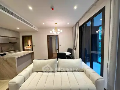 Modern living room with open kitchen and elegant lighting in luxury apartment