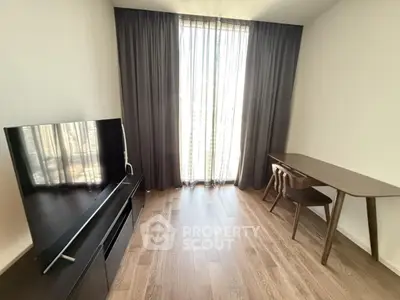Modern living room with sleek TV stand and elegant wooden desk, featuring floor-to-ceiling window with sheer curtains.