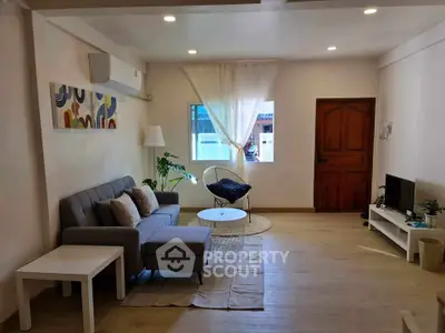 Charming living room with modern decor, cozy sofa, and natural light, perfect for relaxation and entertainment.