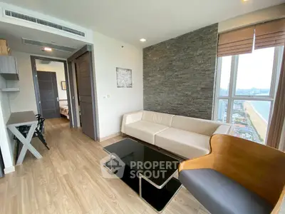 Modern living room with stylish furniture and a stunning city view from the window.
