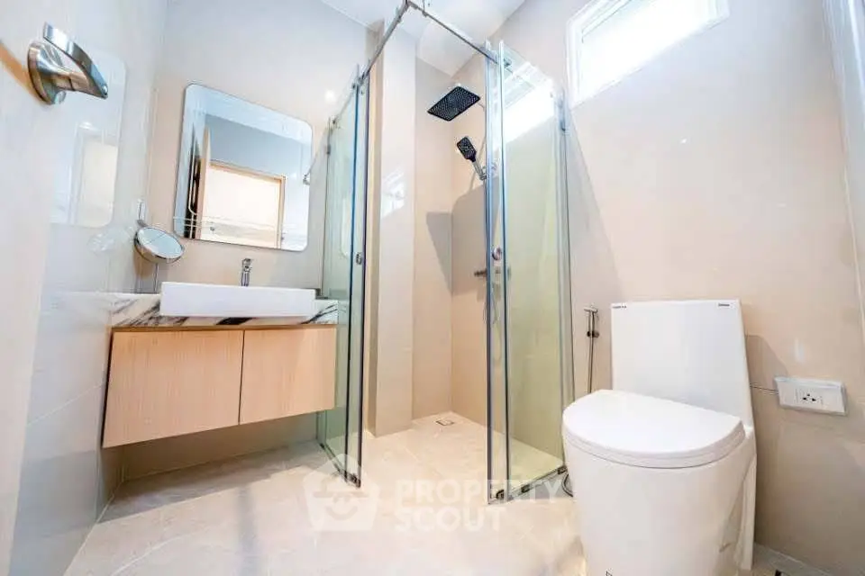 Modern bathroom with glass shower and sleek fixtures