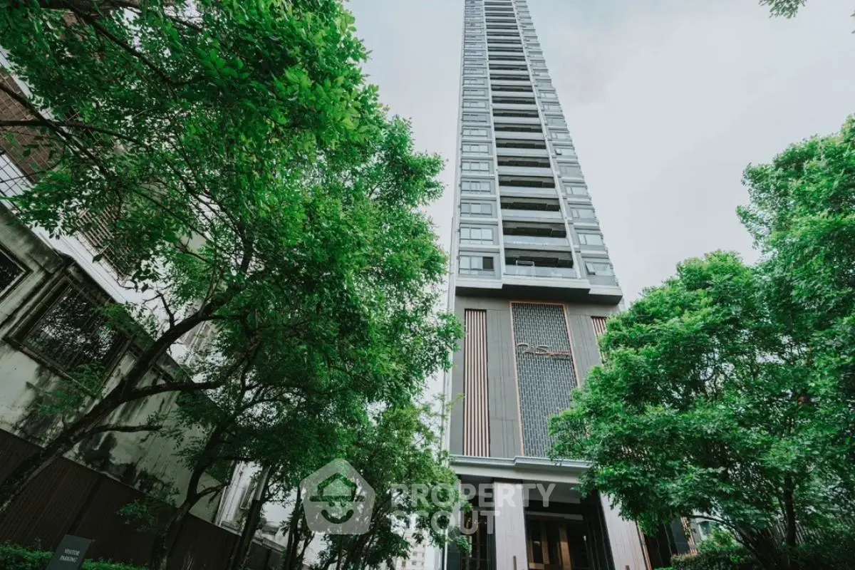 Stunning high-rise building surrounded by lush greenery, offering modern urban living with breathtaking views.