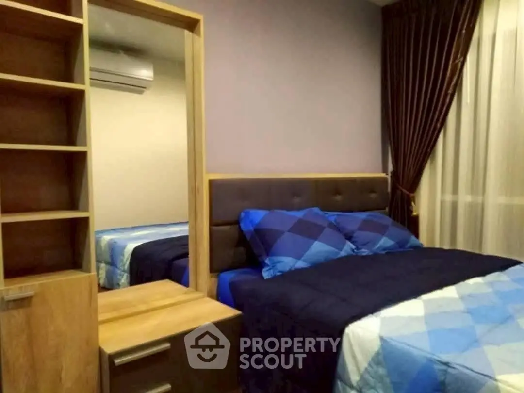 Cozy bedroom with modern decor and ample storage in a stylish apartment.
