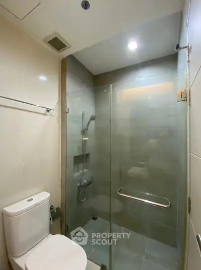 Modern bathroom with glass shower enclosure and sleek fixtures