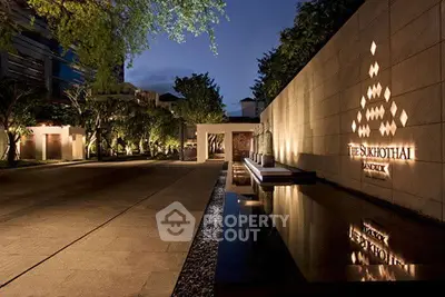 Luxurious modern building entrance with elegant lighting and sleek architectural design.