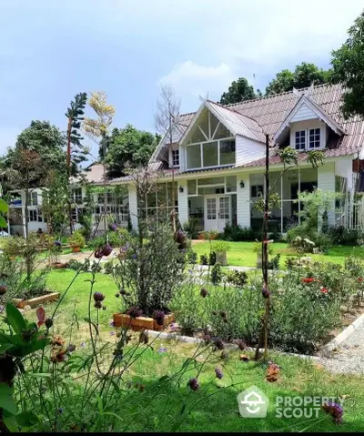 Charming white cottage with lush garden and picturesque landscape