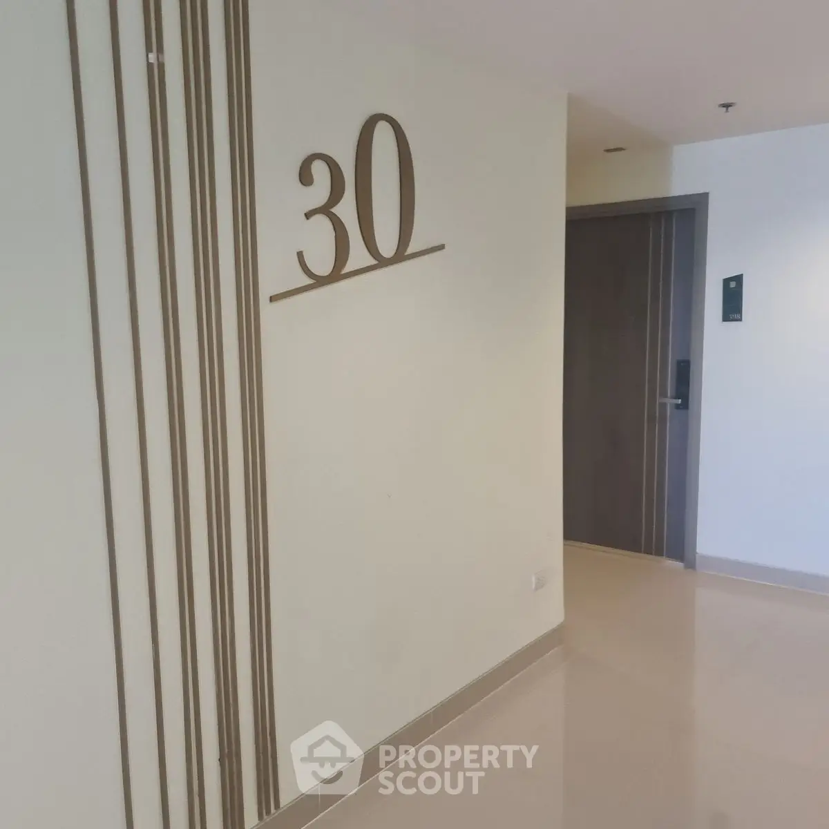 Modern apartment hallway with room number 30 on wall
