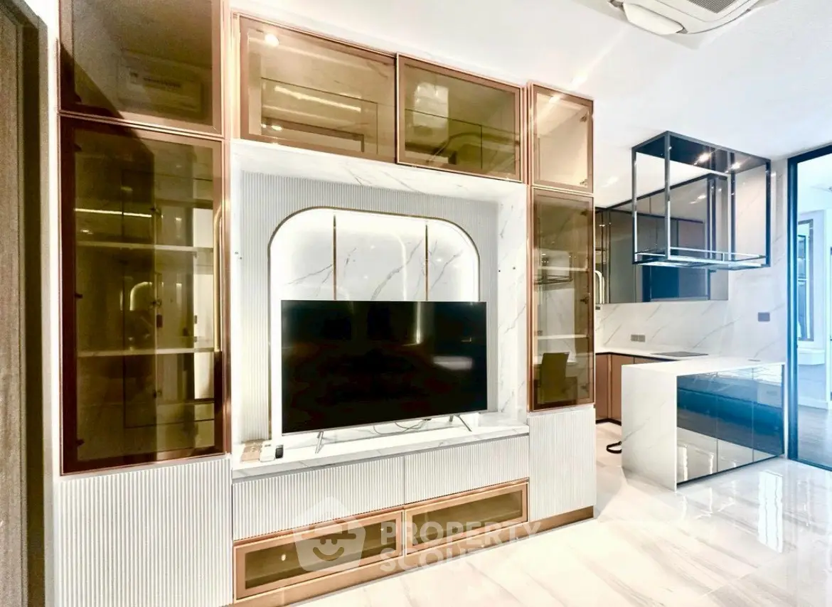 Luxurious modern living room with elegant built-in TV unit and sleek kitchen design.