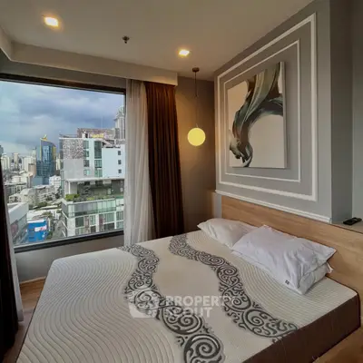Modern bedroom with city view, featuring stylish decor and large window for natural light.