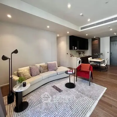 Modern living room with stylish furniture and open kitchen layout in a contemporary apartment.