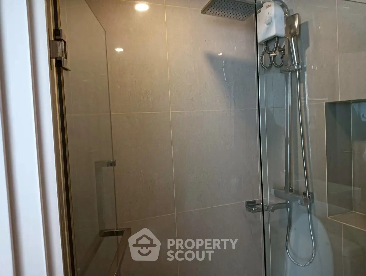 Modern bathroom with glass shower enclosure and sleek fixtures