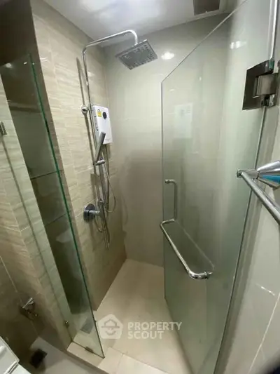 Modern bathroom with glass shower enclosure and sleek fixtures