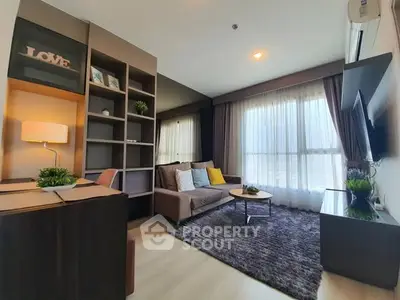 Modern living room with cozy sofa, stylish decor, and large window for natural light.