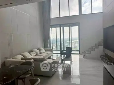 Luxurious living room with high ceilings and panoramic city view, featuring modern furniture and elegant decor.