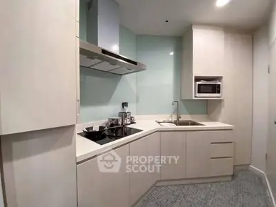 Modern kitchen with sleek cabinetry and built-in appliances