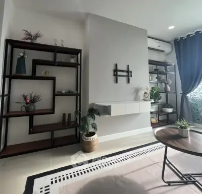 Modern living room with stylish shelving and natural light