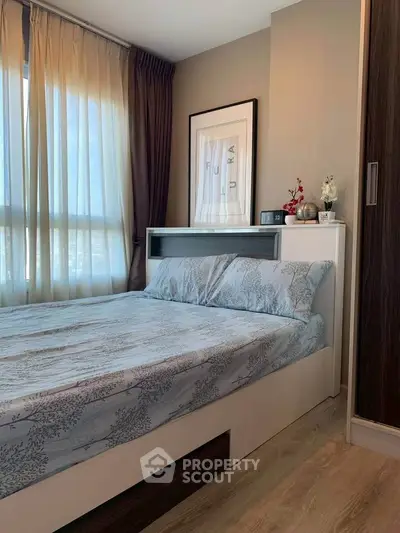 Cozy bedroom with modern decor and natural light, featuring a stylish bed and elegant curtains.