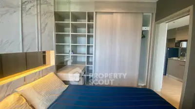 Modern bedroom with built-in storage and stylish decor in a contemporary apartment.