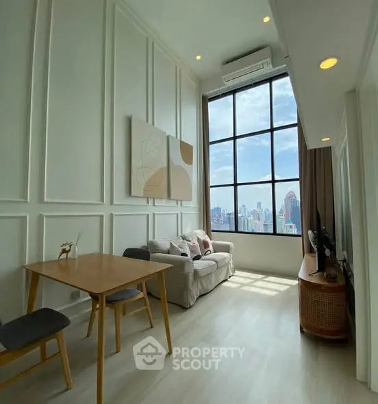 Stunning high-ceiling living room with large window offering breathtaking city views, modern decor, and elegant furnishings.