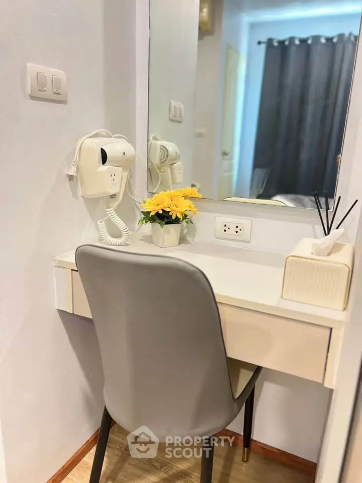 Cozy study nook with modern chair and mirror, perfect for productivity.