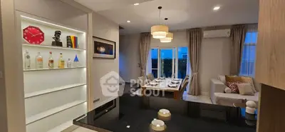 Elegant dining and living area with modern decor and ambient lighting