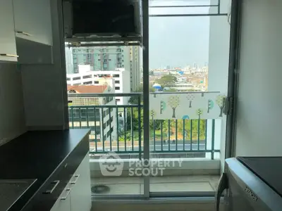 Modern kitchen with balcony view in urban apartment