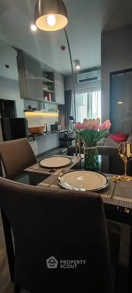 Modern dining area with elegant table setting and stylish decor in a contemporary apartment.