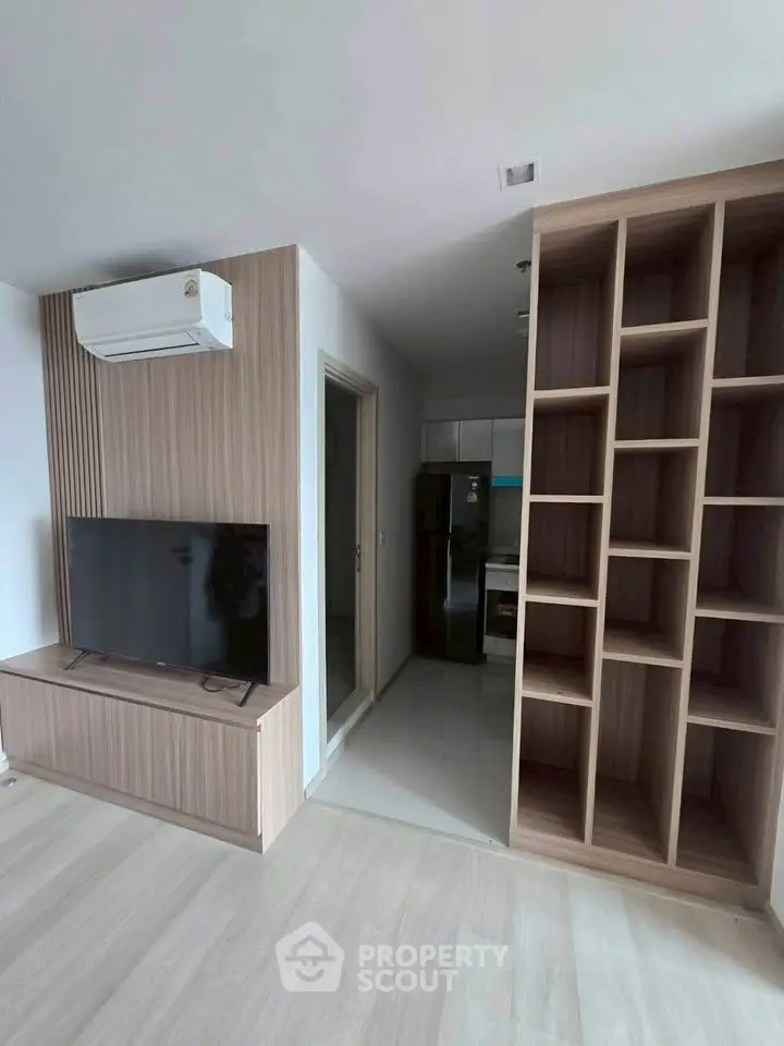 Modern living room with built-in TV unit and open shelving