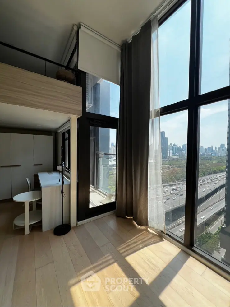 Modern high-rise apartment with floor-to-ceiling windows and stunning city view