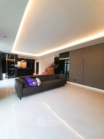 Spacious modern living room with sleek design and ambient lighting