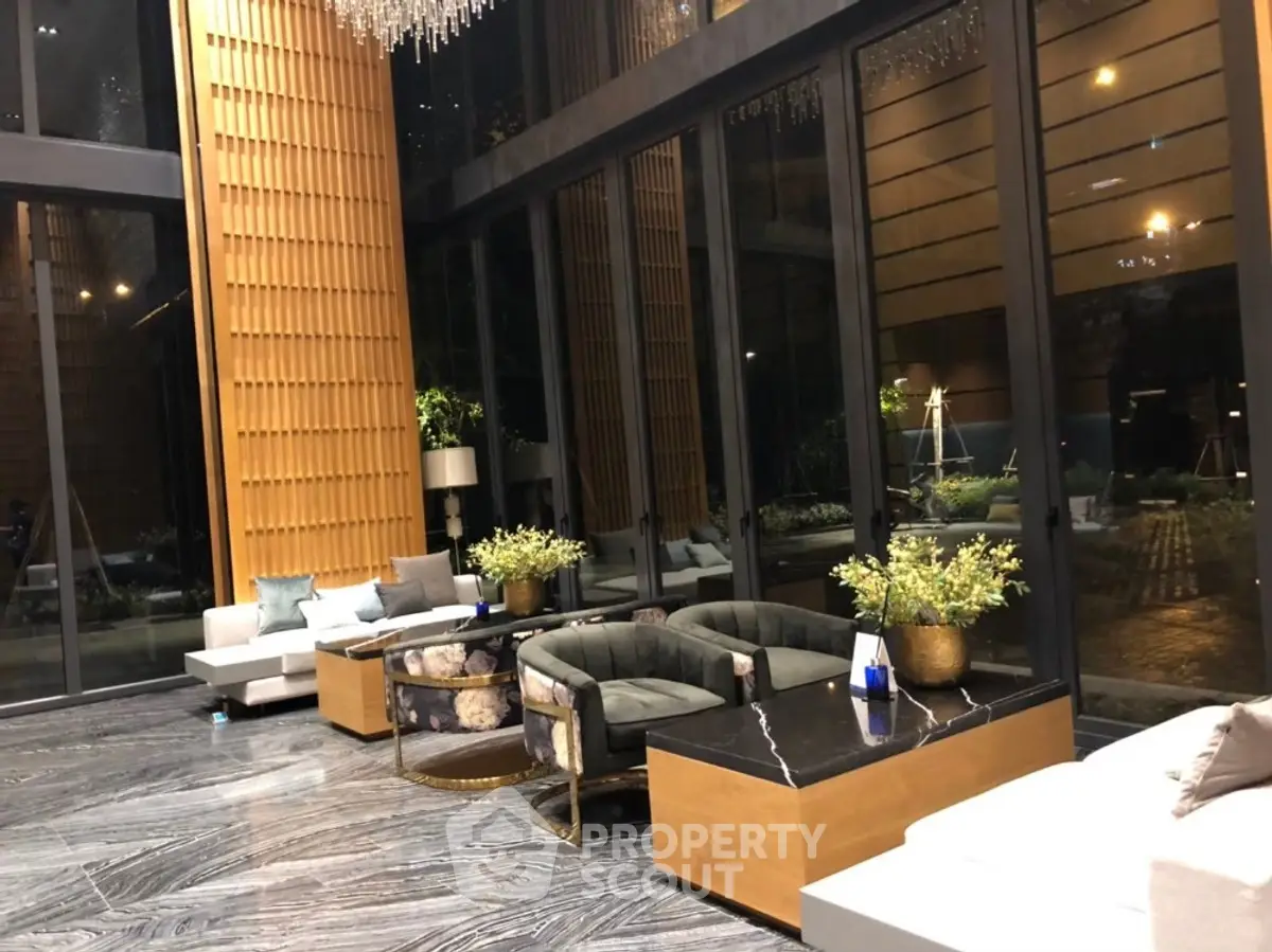 Luxurious modern lobby with elegant seating and floor-to-ceiling windows in a high-end building.