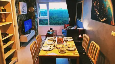 Charming living room with dining area and scenic view, perfect for cozy gatherings.