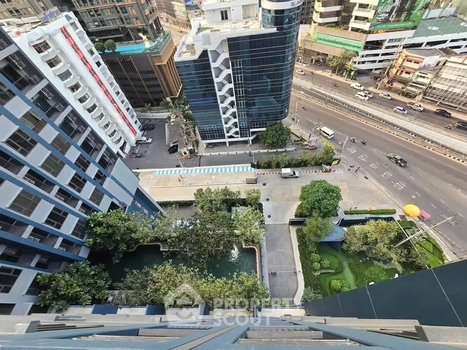 Stunning aerial view of modern urban residential complex with lush greenery and cityscape.