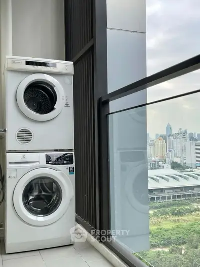 Modern high-rise balcony with washer dryer and stunning city view