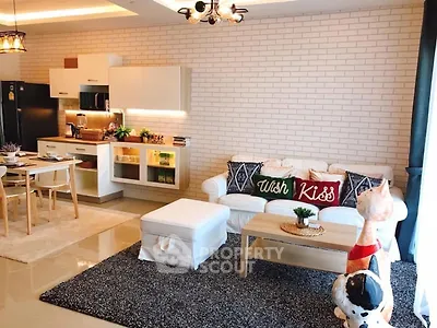 Stylish open-layout living room with modern kitchen and cozy decor
