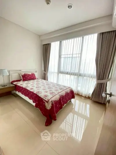 Bright and cozy bedroom with large window and elegant decor