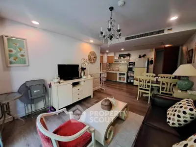 Charming living room with elegant decor and open kitchen layout in modern apartment.