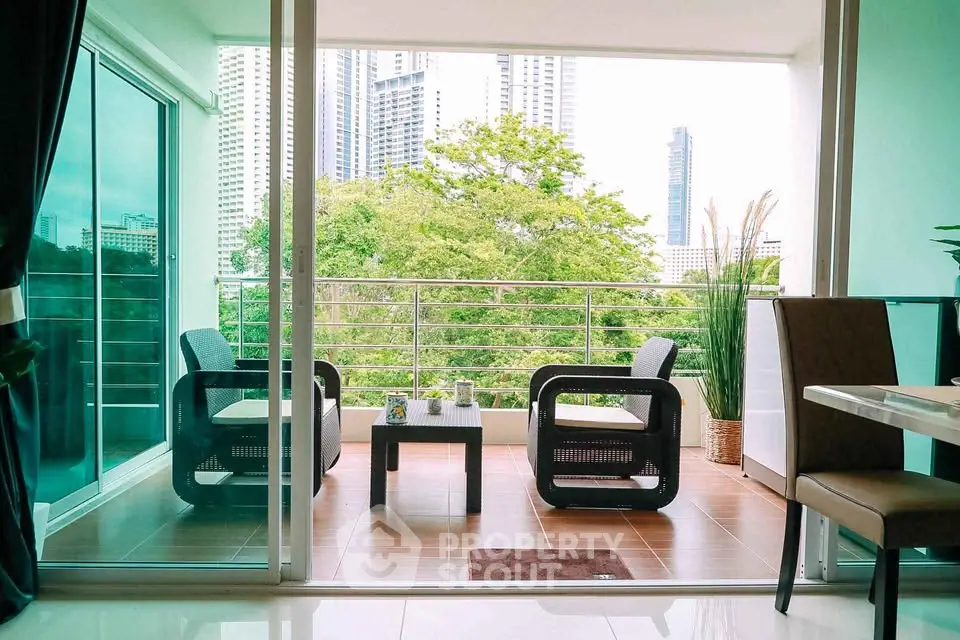 Modern apartment balcony with stylish seating and city view, perfect for relaxation and entertaining.