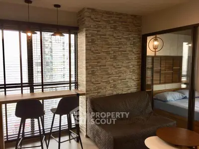 Modern living room with stylish decor and adjacent bedroom view