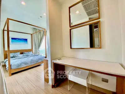 Modern bedroom with stylish decor and wooden flooring, featuring a cozy bed and elegant mirrors.